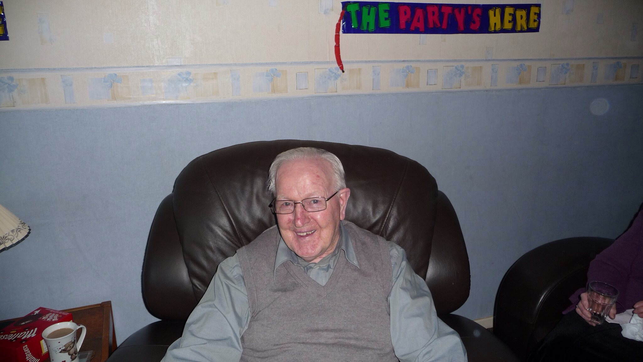 Papa smiling while seated in his armchair